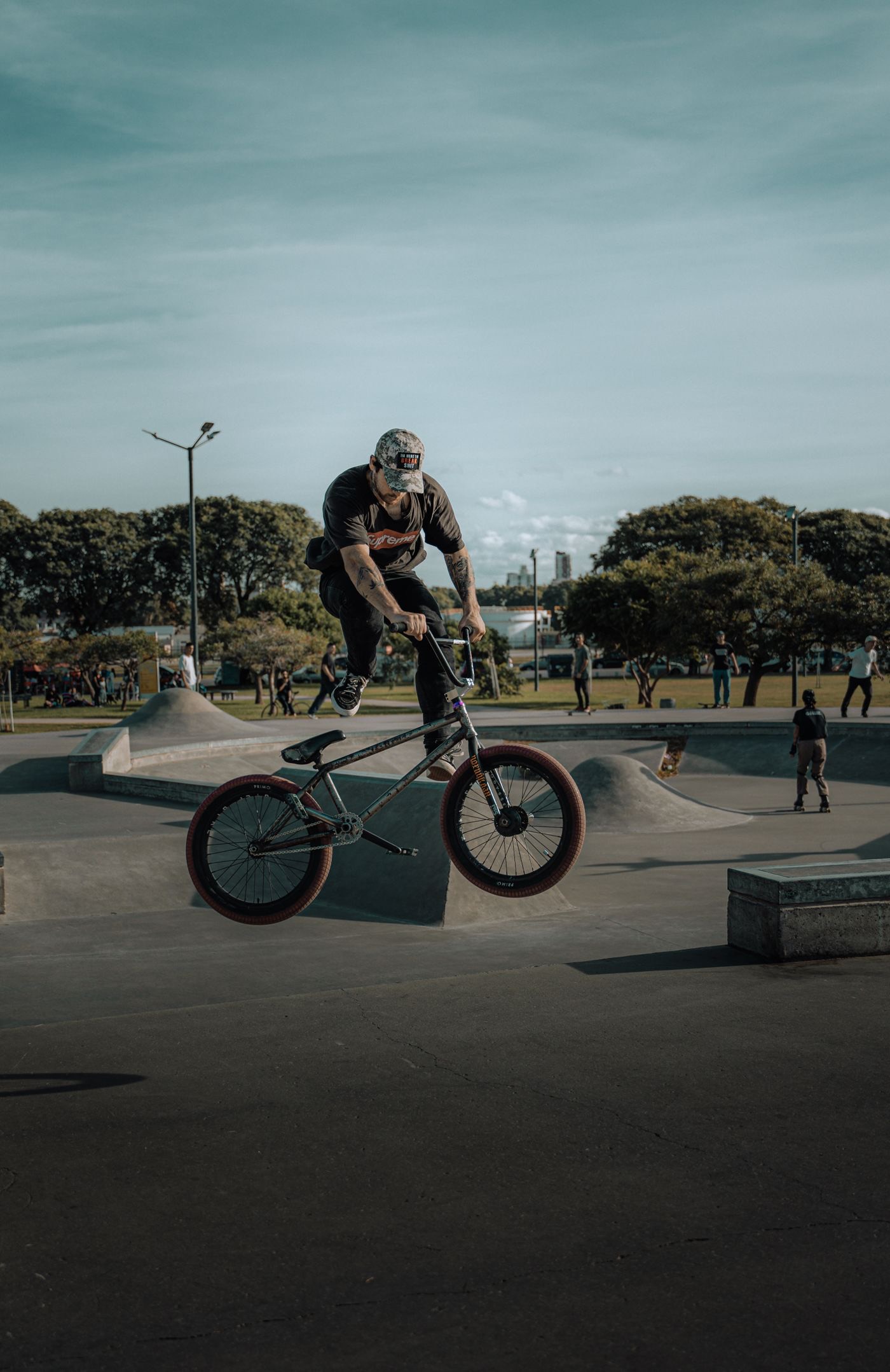 BMX rider mid-air trick at an outdoor skatepark